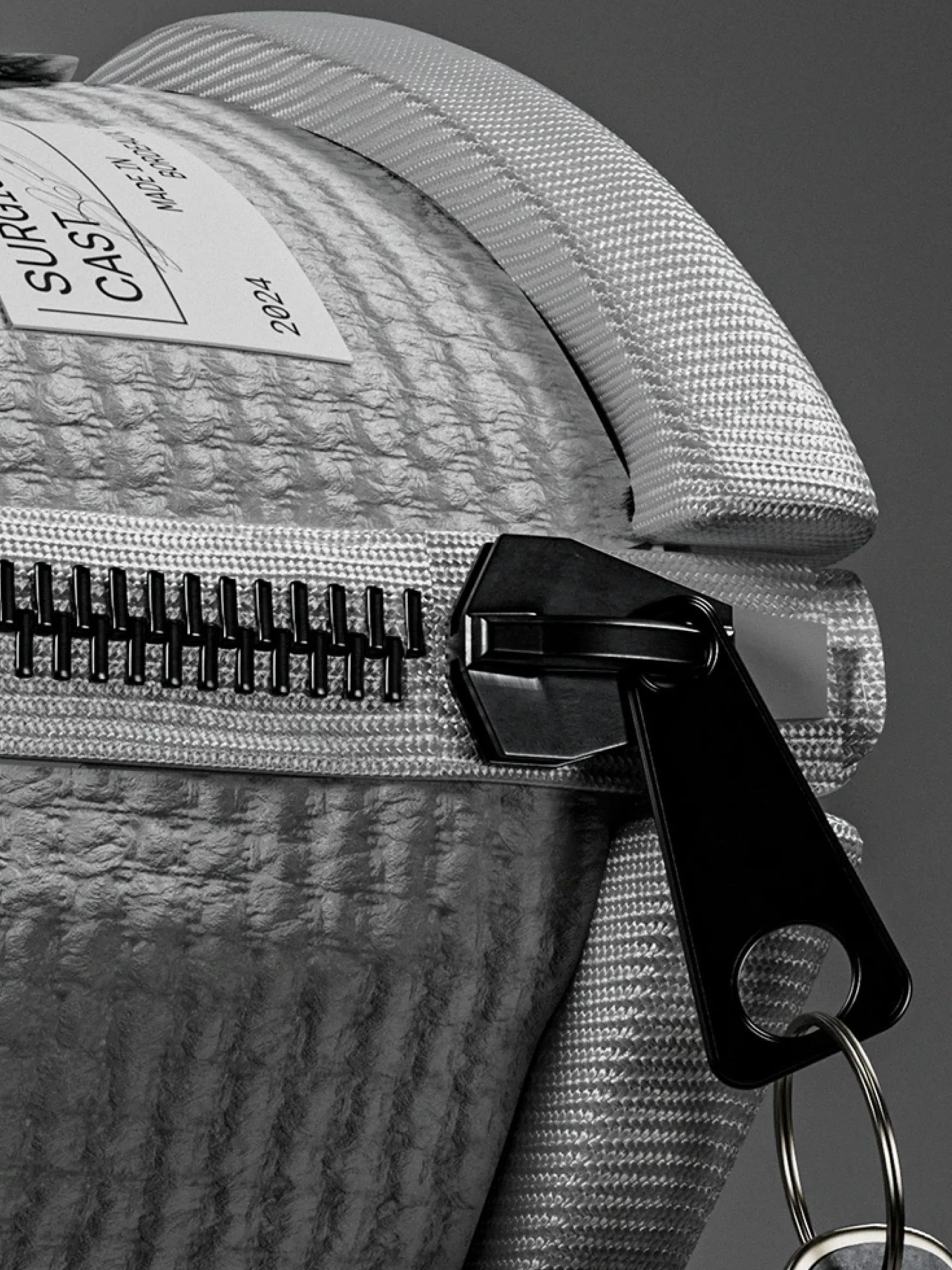 Zipper pull and label detail on the cast